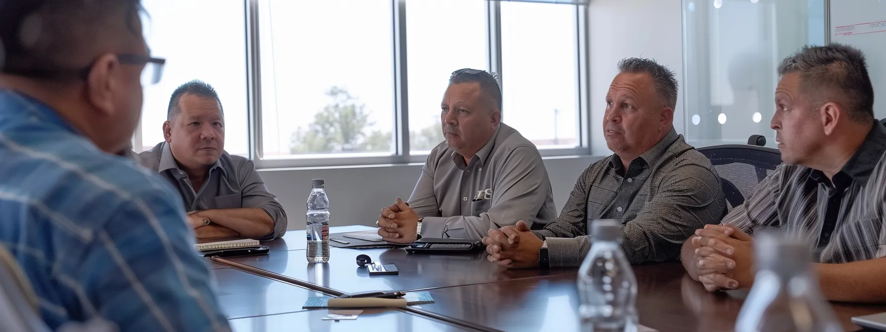 a group of franchise owners discussing local seo strategies at a conference table.